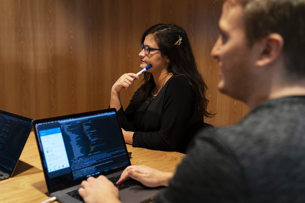 Man and woman in tech meeting