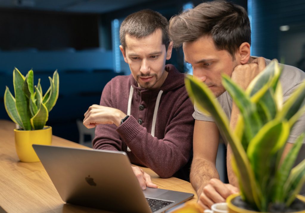 Two people looking at computer together