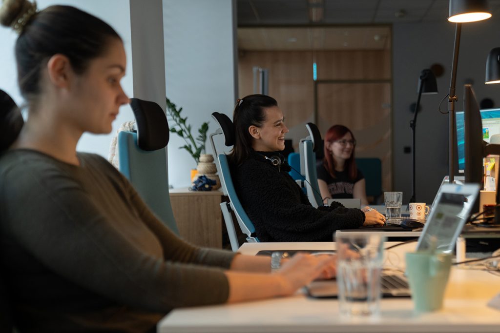 Three women at work, relaxed and smiling