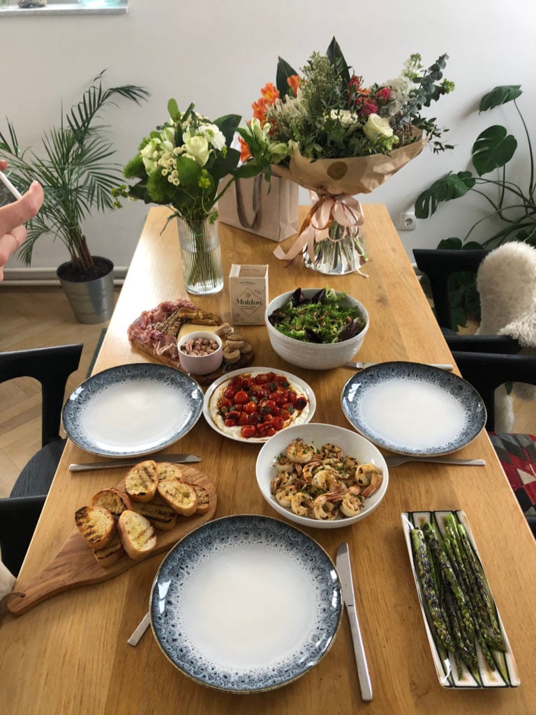An image of a table full of breakfast dishes and flowers