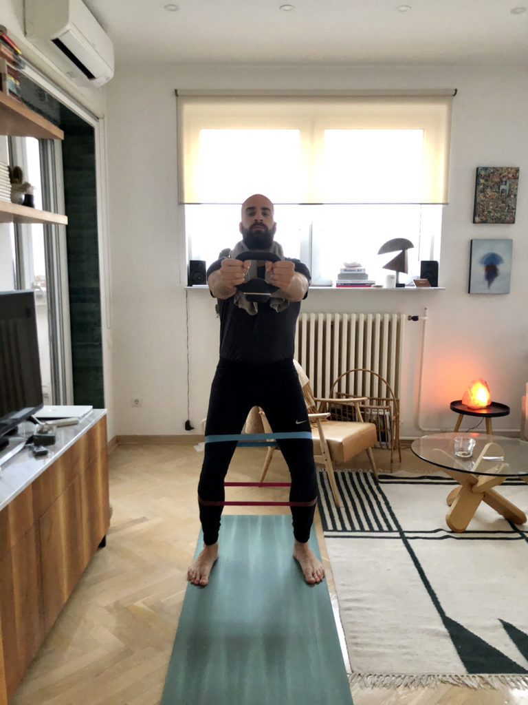 An image of a man working out in an apartment