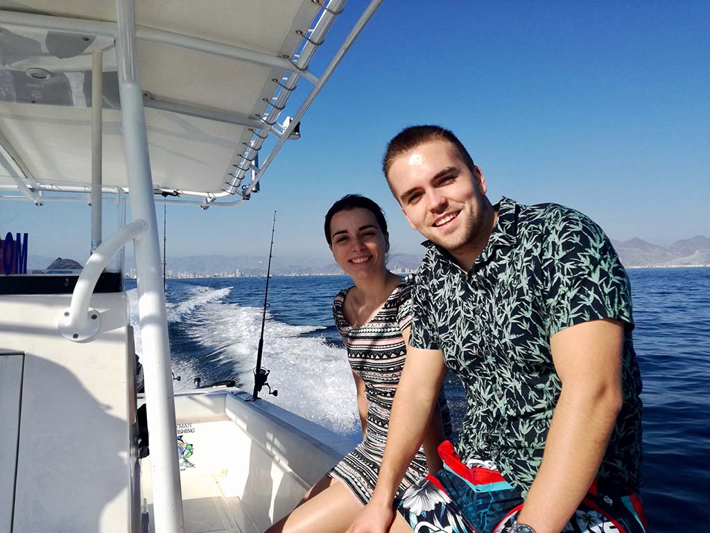 A man and a woman sitting on a boat on a sunny